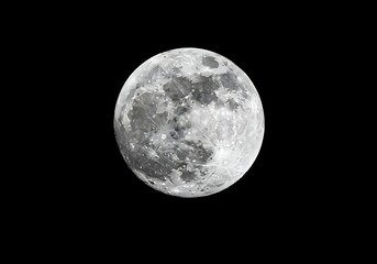 Fototapeta premium Photo of the full moon is isolated on a black background, showing its craters