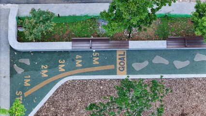 Outdoor Fitness Track With Distance Markers And Greenery