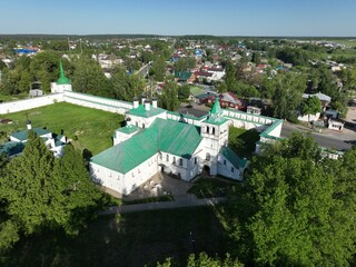 An expansive aerial panorama of Kirzhach city, prominently featuring the Holy Annunciation Monastery within the urban fabric