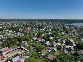 An aerial view showcasing the urban landscape of Kirzhach city with a mix of buildings and green spaces under a clear sky