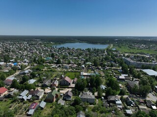 An aerial view focusing on a residential area within Kirzhach city, featuring houses and plots of land