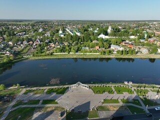 An aerial view of Kirzhach cityscape, featuring a winding river and a bridge, connecting different parts of the city