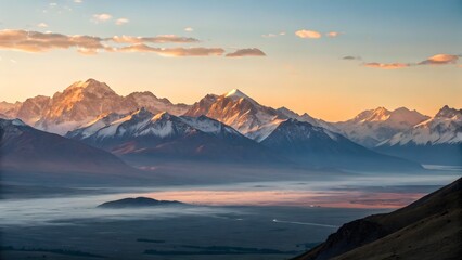 Majestic Mountain Vista: A breathtaking panorama of snow-capped mountains stretches across the horizon, bathed in the soft hues of dawn and a blanket of mist.