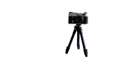 Vintage camera on tripod in dramatic darkness