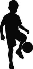 Silhouette of a young boy juggling a soccer ball
