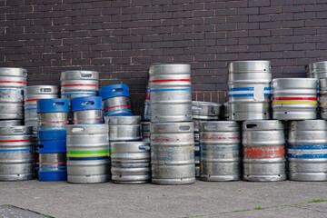 Beer and alcohol barrel kegs in a stack outside pub