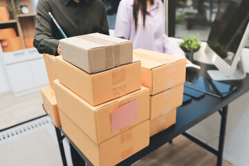Portrait of Starting small businesses SME owners, two Asian woman check online orders Selling...