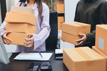 Portrait of Starting small businesses SME owners, two Asian woman check online orders Selling...