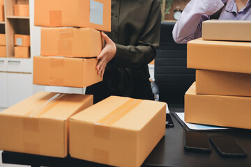 Portrait of Starting small businesses SME owners, two Asian woman check online orders Selling...