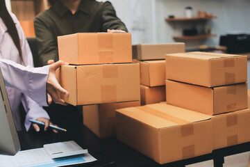 Portrait of Starting small businesses SME owners, two Asian woman check online orders Selling...