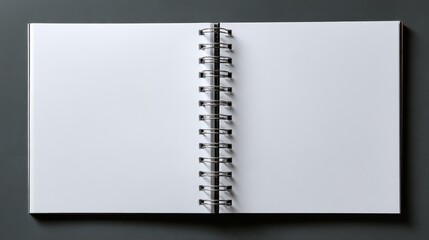 Top view of an open blank spiral notebook with a white cover, ready for drawing, writing, planning, sketching, or making notes.