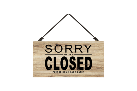 A closed sign posted on glass door of store. Concept of shop service business closed on holidays.