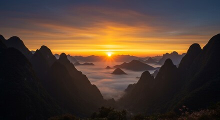Naklejka premium Majestic Mountain Peaks at Sunrise Over Sea of Clouds