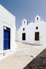Whitewashed Church and Blue Door in a Quiet Alley of Amorgos