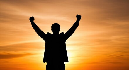 Fototapeta premium A silhouette of a triumphant person celebrating with arms raised against a golden sunset, symbolizing personal success and achieving goals.
