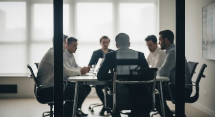 Fototapeta premium A silhouette of a team of businessmen in a private meeting, viewed through the glass wall of a boardroom. A concept for confidential corporate discussions.