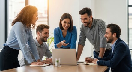A cheerful diverse team working together on a laptop in a sunlit office. A creative group of colleagues collaborating on a business project.