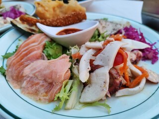 Detail of a mixed fish antipasto platter, a dish consisting of a variety of fish dishes served as an appetizer, or starter, to begin a meal.