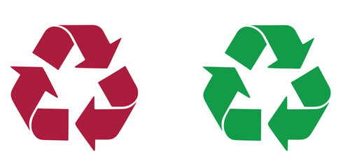 Two recycle symbols one in black and one in green on a white background studio shot