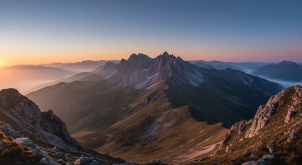 Majestic Mountain Range at Sunrise with Foggy Valleys