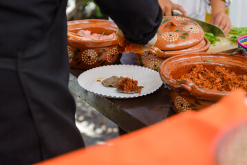 Preparation of cochinita pibil taco at a street food stand.1