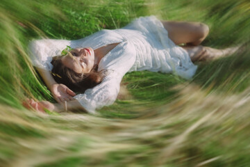  Romantic woman lying in the grass