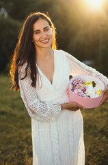 Portrait of a beautiful laughing woman with a box of marshmallows