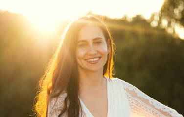 Portrait of a beautiful laughing woman at sunset