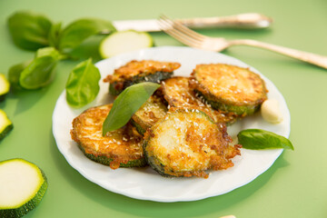 Fried zucchini with garlic and basil served hot