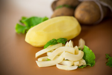 Striped potatoes next to a sack on a brown background