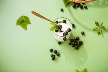 Berry breakfast with yogurt, green isolated background
