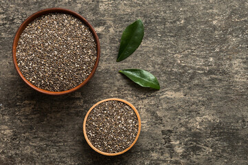 Chia seeds in bowl on colored background. Healthy Salvia hispanica in small bowl. Healthy superfood