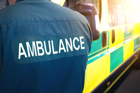 Ambulance and paramedic - emergency services worker and ambulance vehicle on standby. Medically equipped for patients and paramedics. Transport for health care facility or hospital, for treatment.