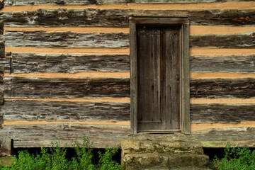 A wooden door entrance to a log cabin