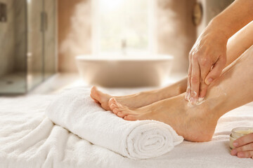 Foot massage, self-care and skin nourishment, applying moisturizing cream, home self-care, skincare...