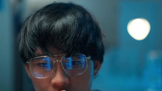 Close-up programmer reflecting code screen in glasses software developer focus technology system digital interface