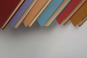 Open book, hardback colorful books on table. Back to school. Copy space for text. Education business concept