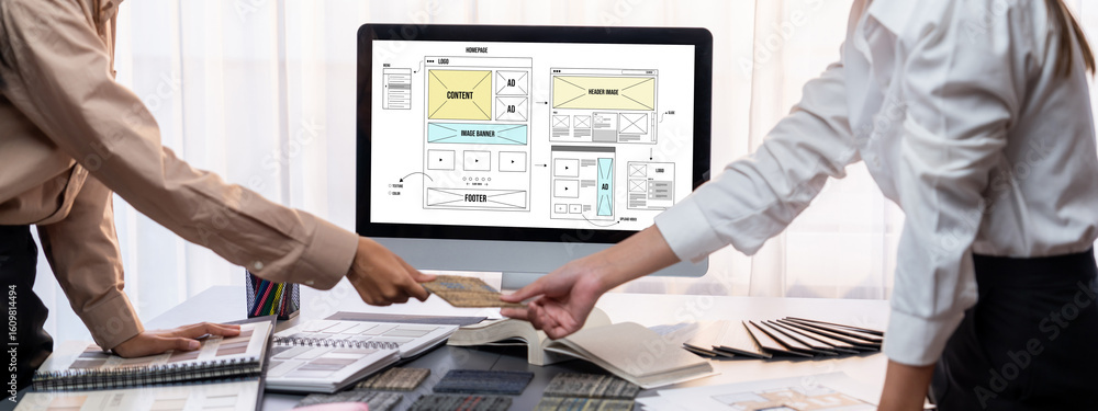 Poster group of interior architect designer team at table choosing various mood board samples with architec