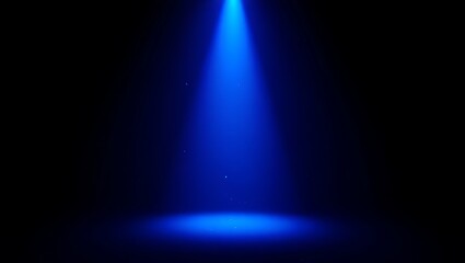 Bright blue spotlight illuminating a dark stage with a circular pool of light