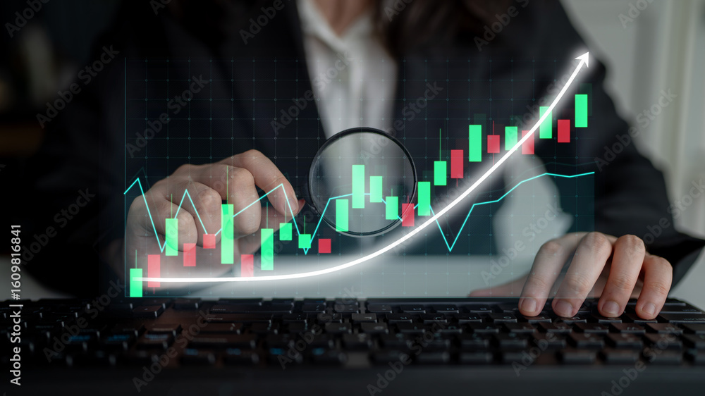 Poster businessperson examines stock market trends using a magnifying glass while working at a keyboard in 