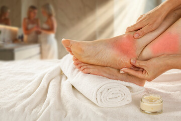 Woman gently massaging sore feet and ankle, focusing on pain relief and relaxation, muscle fatigue,...