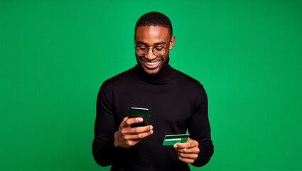 Man online shopping with credit card and mobile phone on green screen background