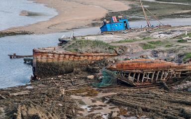old abandoned sunken ship in the water at the ship cemetery