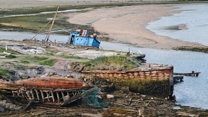 old abandoned sunken ship in the water at the ship cemetery
