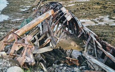 old abandoned sunken ship in the water at the ship cemetery