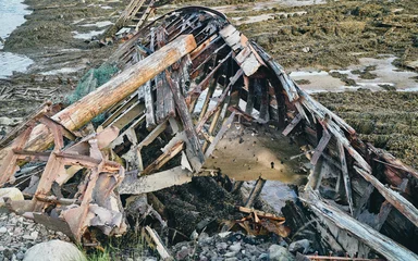 Rolgordijnen old abandoned sunken ship in the water at the ship cemetery © Sofiia