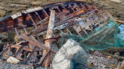 old abandoned sunken ship in the water at the ship cemetery