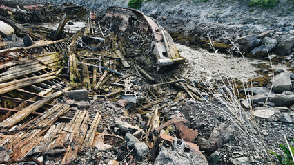 old abandoned sunken ship in the water at the ship cemetery