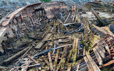 old abandoned sunken ship in the water at the ship cemetery