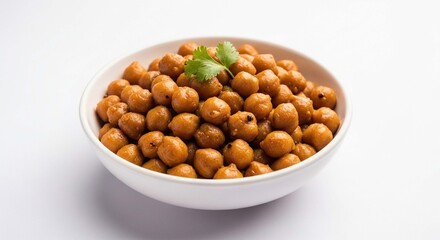 A white bowl filled with golden brown roasted chickpeas, garnished with a fresh green cilantro sprig, presented against a clean white background.